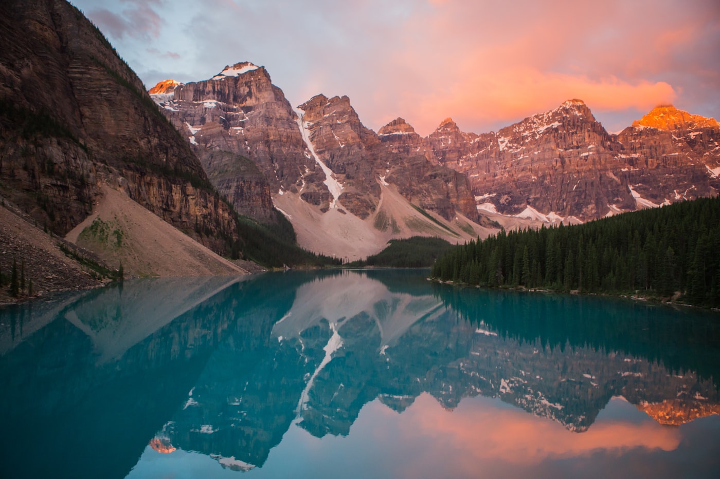 Mountain landscape reflected near water under open sky